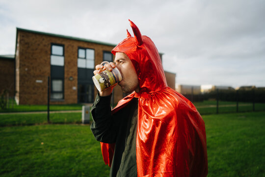 Young man in devil costume 