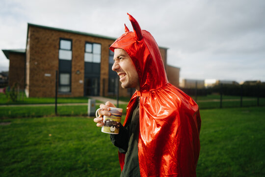 Happy man in devil costume 
