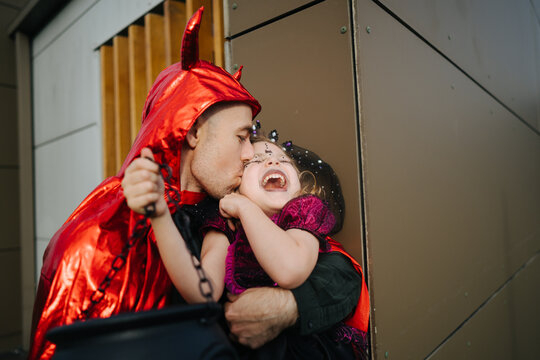 Father and daughter dresses up in costumes
