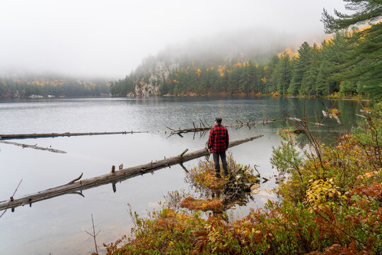 Man Standing at Misty Mountain Lake Hiking in Autumn