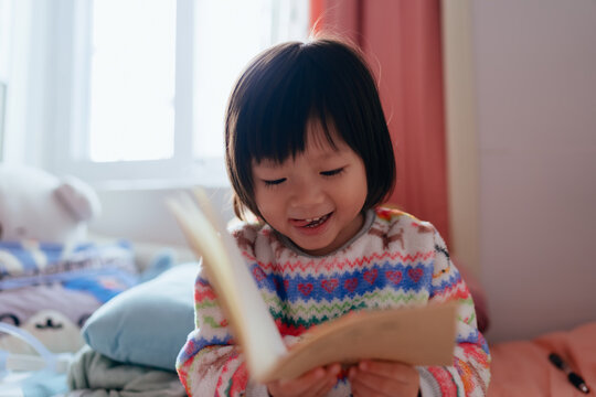 little girl leisurely learning to read