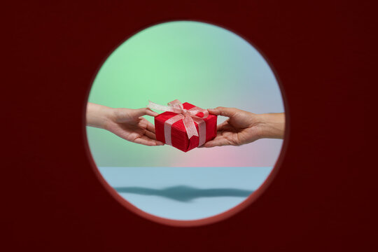 anonymous female with manicure giving gift boxs with bows