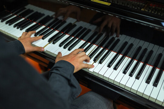 ugc of teenager playing a grand piano