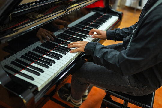 ugc of teenager playing a grand piano