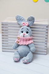 gray bunny soft toy with pink scarf