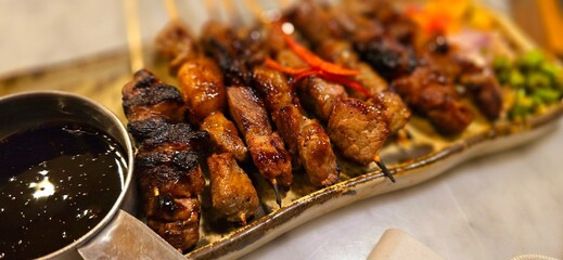 Homemade beef Satay marinated with spice and sweet soy sauce, coriander beef satay, served on plate...