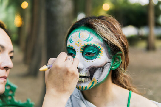 Portrait of a young woman characterized as a catrina.