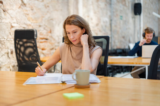 Middle-Aged Woman In Modern Workplace