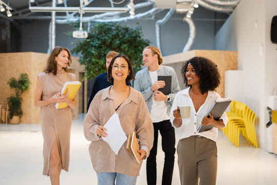 Group Of Diverse Colleagues Walking In Office