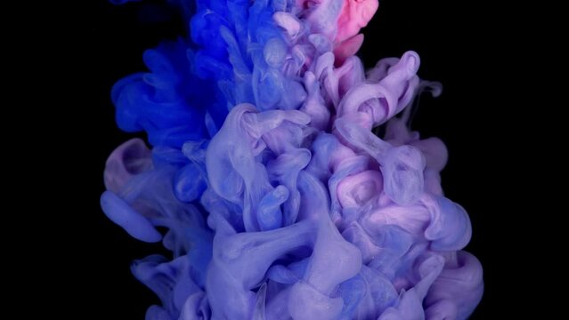 Acrylic paint drops in motion create a texture with vibrant purple, blue, and pink hues.