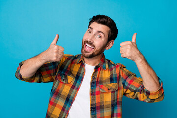 Photo of cheerful friendly man with beard dressed plaid shirt raising thumbs up approve nice job...