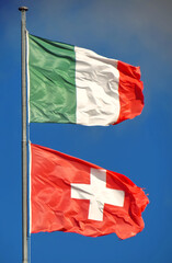 Pole with Italian and Swiss flag.