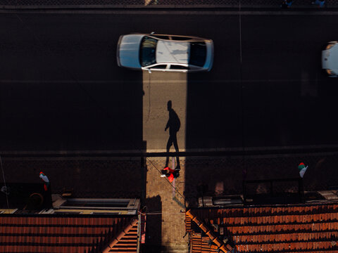 Drone shot of street with long shadows. Traffic and movement concept.