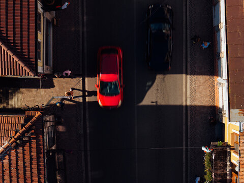 Drone shot of street with long shadows. Traffic and movement concept.