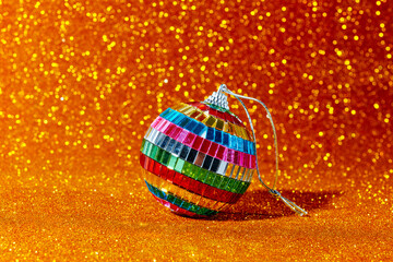 shiny mirror christmas ball on a golden glittering surface