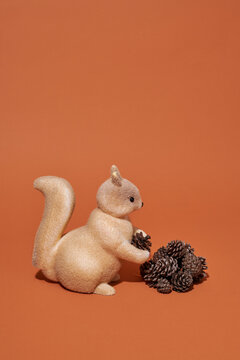 toy squirrel saving some pine cones