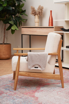 Stylish men's polo shirt lying on an armchair