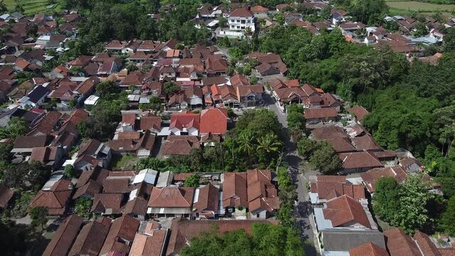 Fly above the rooftops and streets of a small village in Yogyakarta