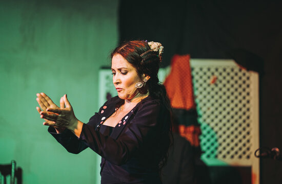 Adult woman performing dance with clapping on stage