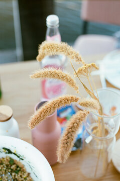 Dreamy summer still life with reed in vase on a table