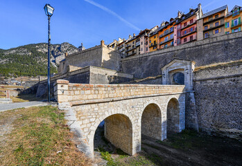Stone bridge leading to the Gate of Embrun in the fortified wall of Briançon, a city built by Vauban in the French Alps
