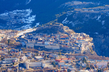 Aerial view of the walled city of Briançon built by Vauban on top of a rocky spur in a mountainous valley of the French Alps - obrazy, fototapety, plakaty