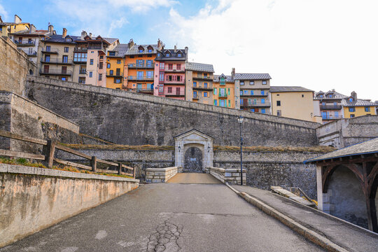 Gate of Embrun in the fortified wall of Briançon, a city built by Vauban in the French Alps - Citadel with colorful houses on top of a rocky spur in a mountainous valley in France