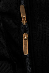 "Zipper on black background: minimalist and modern detail of a zipper closure in contrast to the dark background
