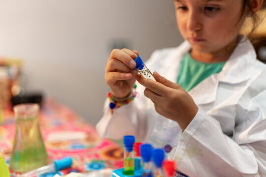 Girl playing with science toys at home