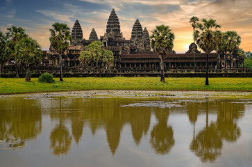 Fototapeta na wymiar Angkor Wat Temple Complex reflected in the lake at Sunrise - UNESCO World Heritage 12th century masterpiece of Khmer Architecture built by Suryavarman II at Siem Reap, Cambodia, Asia