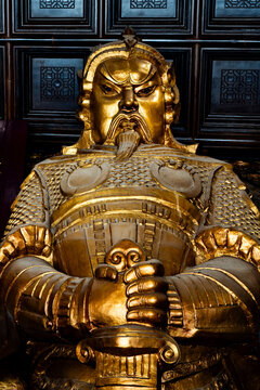 Golden Che Kung statue at a Buddhist temple in Hong Kong