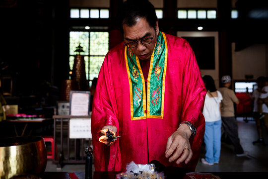 A Buddhist performs a ritual with fire at a Thai temple in Hong Kong.