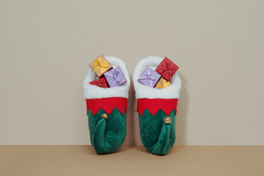 pair of pointy elf shoes full of gifts