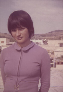 1974. A young woman dressed in the fashion of the time