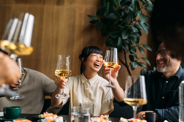 Group of people toasting in restaurant