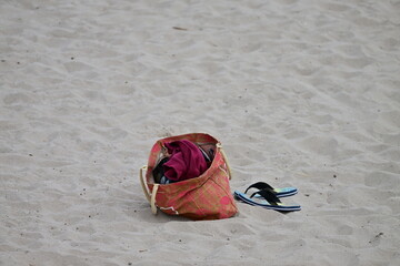 An abandoned bag with personal belongings at the beach of Benidorm-Spain. 