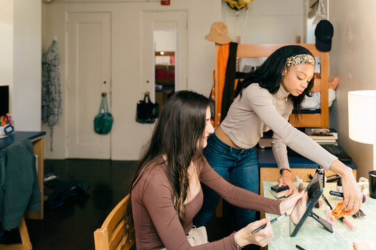 young women doing their make up 