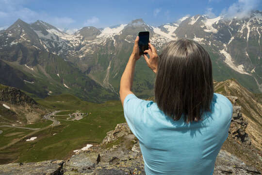 A man taking pictures of the mountains