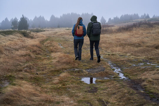 Couple walking in autumn wind