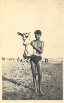 Summer '52: Boy with a giant rabbit puppet on the beach