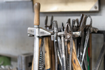 Old iron hand tools, pliers, hammers in a workshop