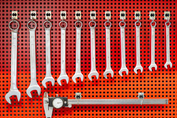 Wrenches and tools on a red metal tool cabinet