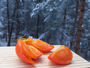Slices of sweet juicy persimmon. Seasonal winter fruit.