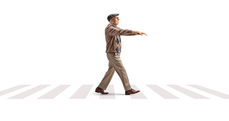 Full length profile shot of an elderly man sleepwalking at a pedestrian crossing