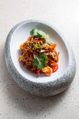 Asian dish with noodles, meat and herbs