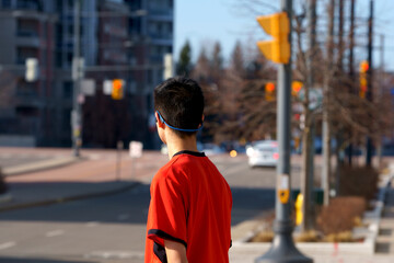 A teenager was waiting at the traffic light.