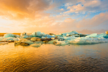 Stunning sunset over floating icebergs,  Jokulsarlon Glacier Lagoon, Iceland - obrazy, fototapety, plakaty
