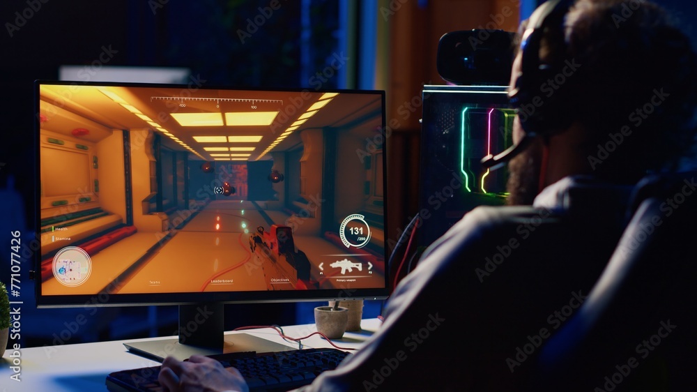 Poster man relaxing by playing futuristic science fiction videogame on pc at computer desk late at night. g