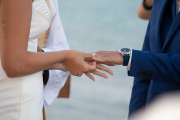people shaking hands, exchange of rings, wedding, close-up of the groom holding a ring, close-up of...