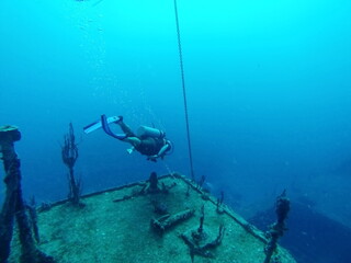 SCUBA diver on a shipwreck in the Caribbean Sea, off the coast of Utila, Honduras